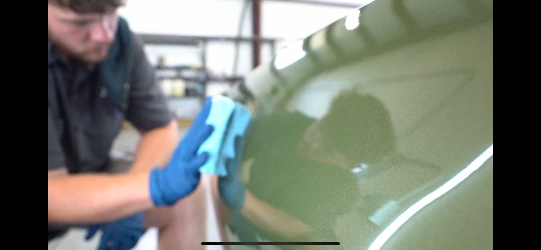 Technician applying ceramic coating to a vehicle at Envy This Detailing in College Station TX ensuring durable protection and a high-gloss finish