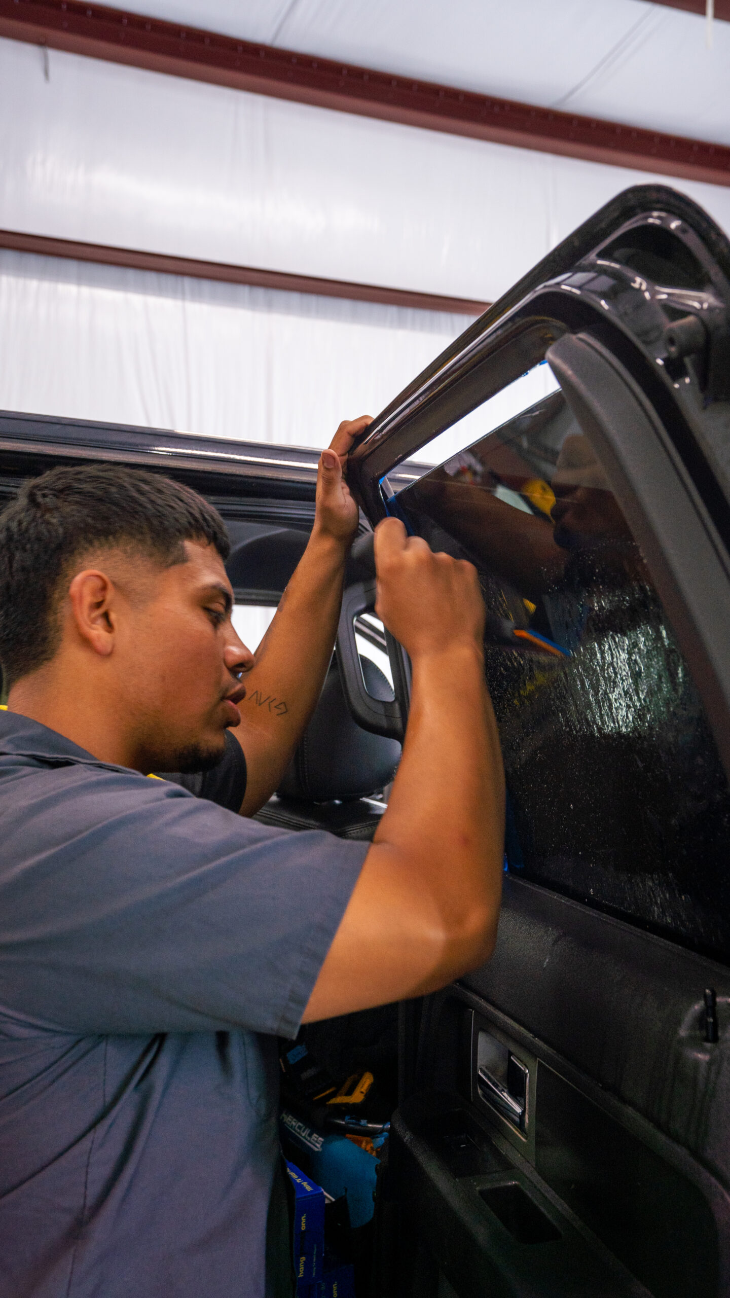 Professional window tint application on a car at Envy This Detailing in College Station, TX, ensuring enhanced privacy, UV protection, and sleek aesthetics.