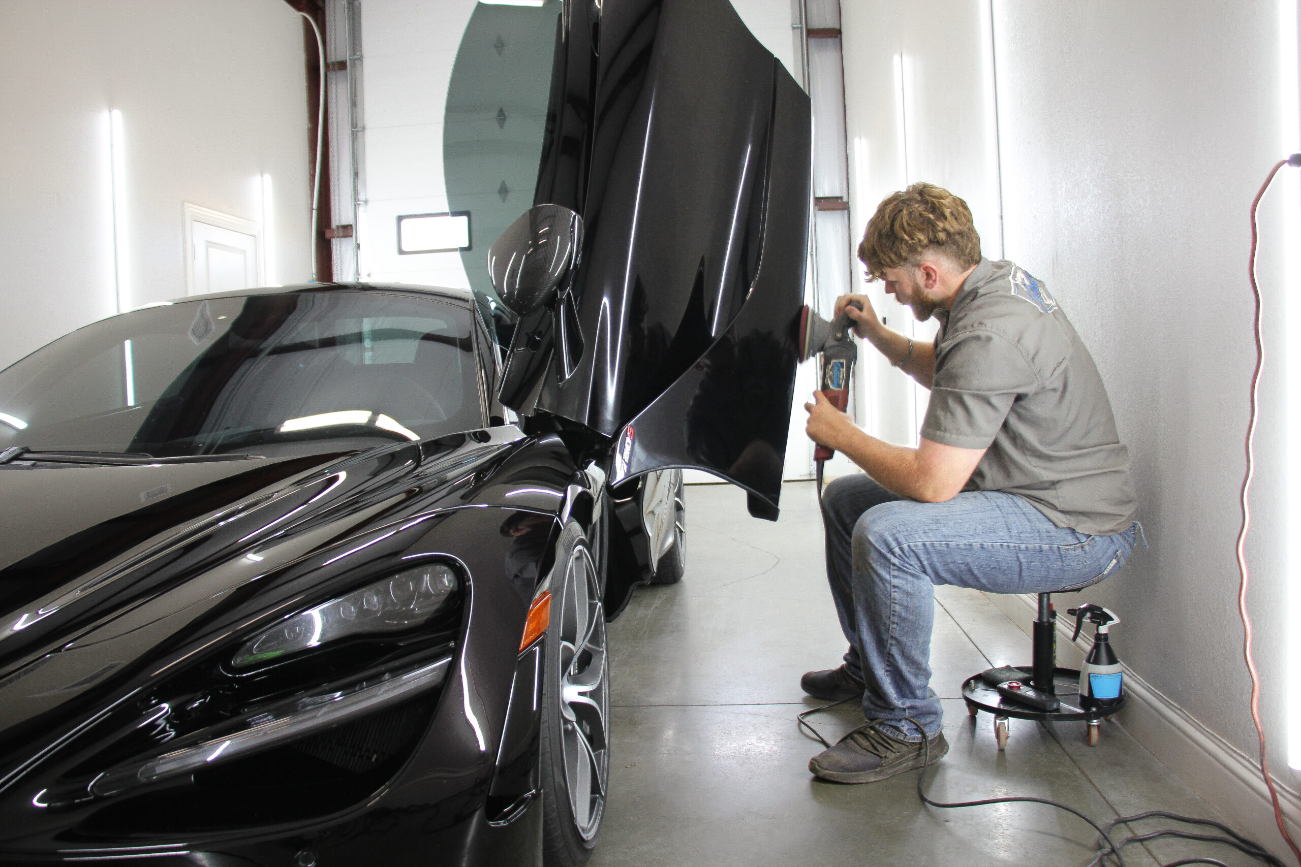 Technician installing paint protection film at Envy This Detailing in College Station, TX