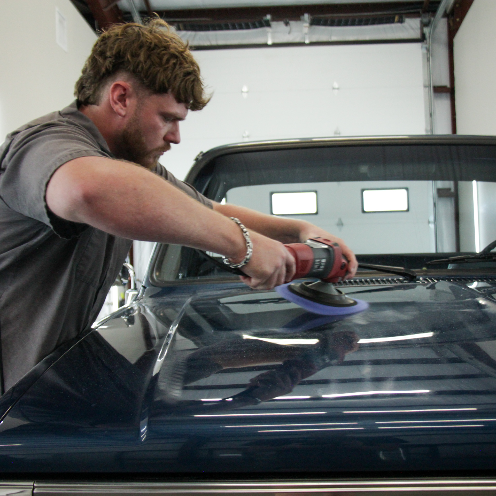 Professional paint correction service restoring gloss and removing swirl marks from a luxury vehicle in College Station, TX by Envy This Detailing.