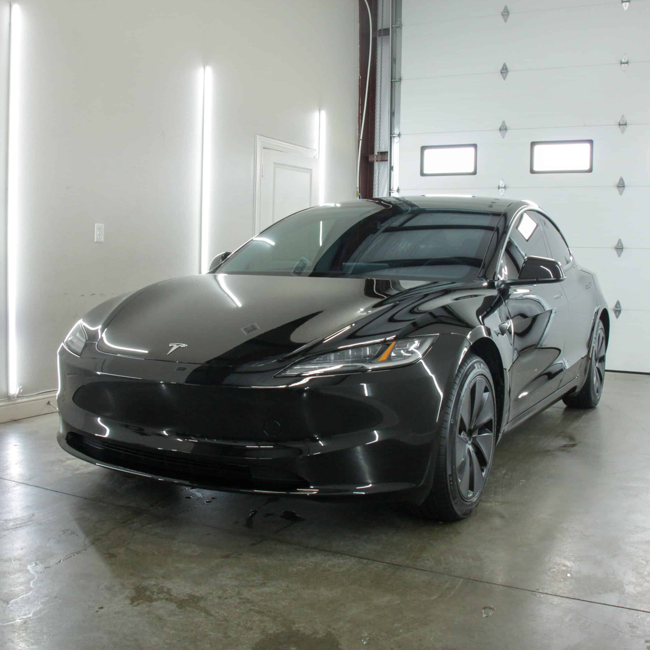 Tesla Model 3 receiving professional ceramic coating and paint protection film at Envy This Detailing in College Station, TX—expert EV paint protection and gloss enhancement.