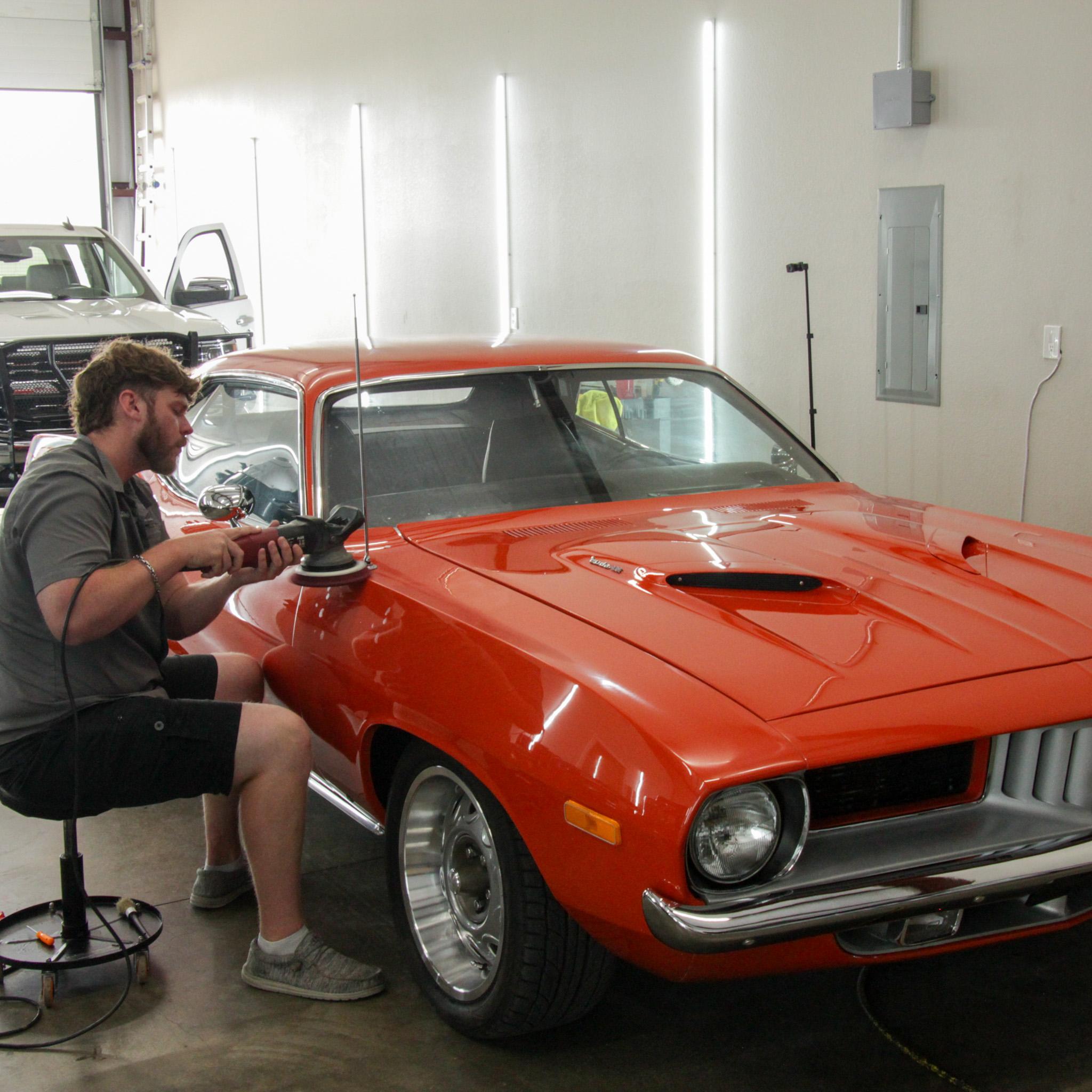 Car owner enjoying the benefits of professional ceramic coating on their vehicle