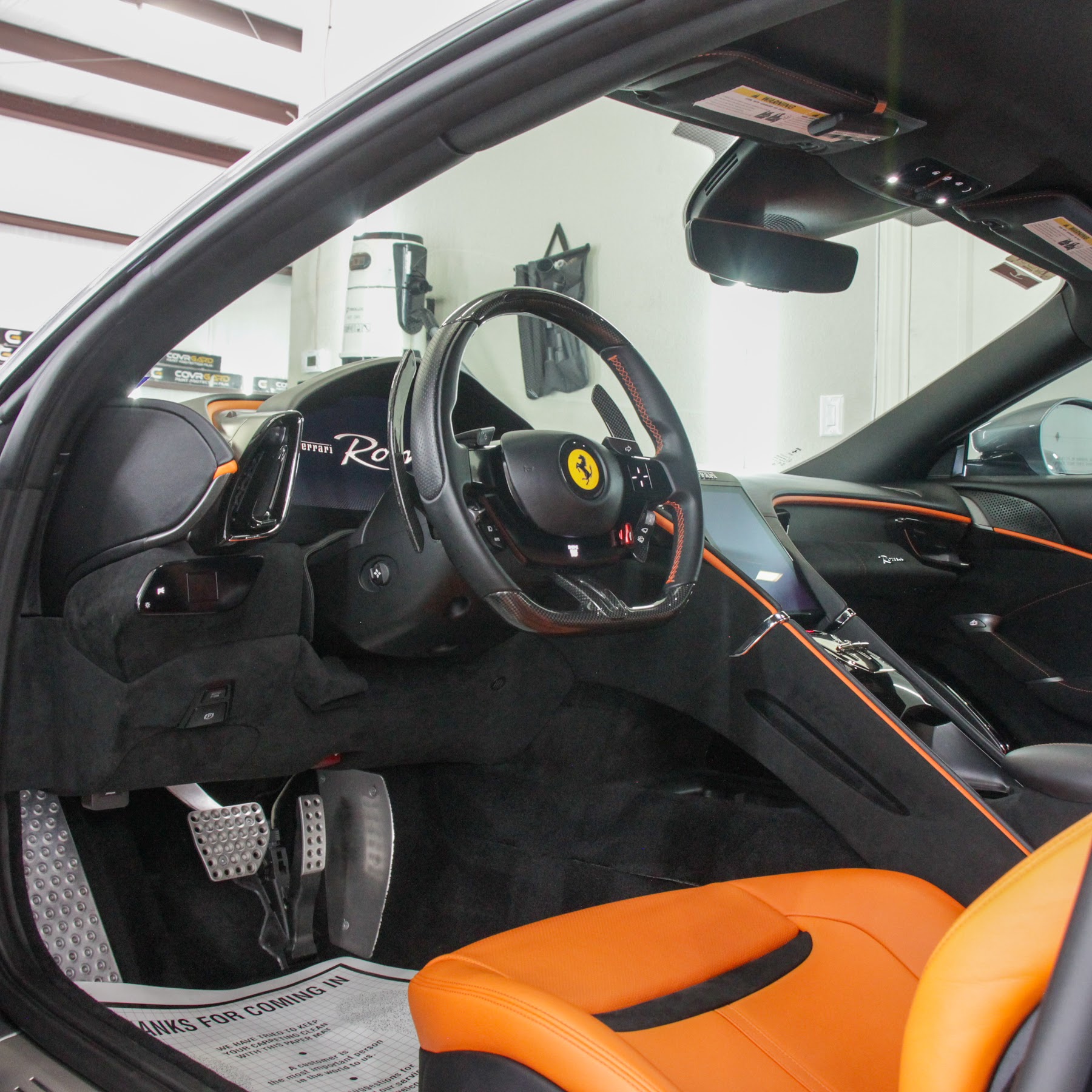 Ferrari interior with orange seats after interior detailing in College Station, TX