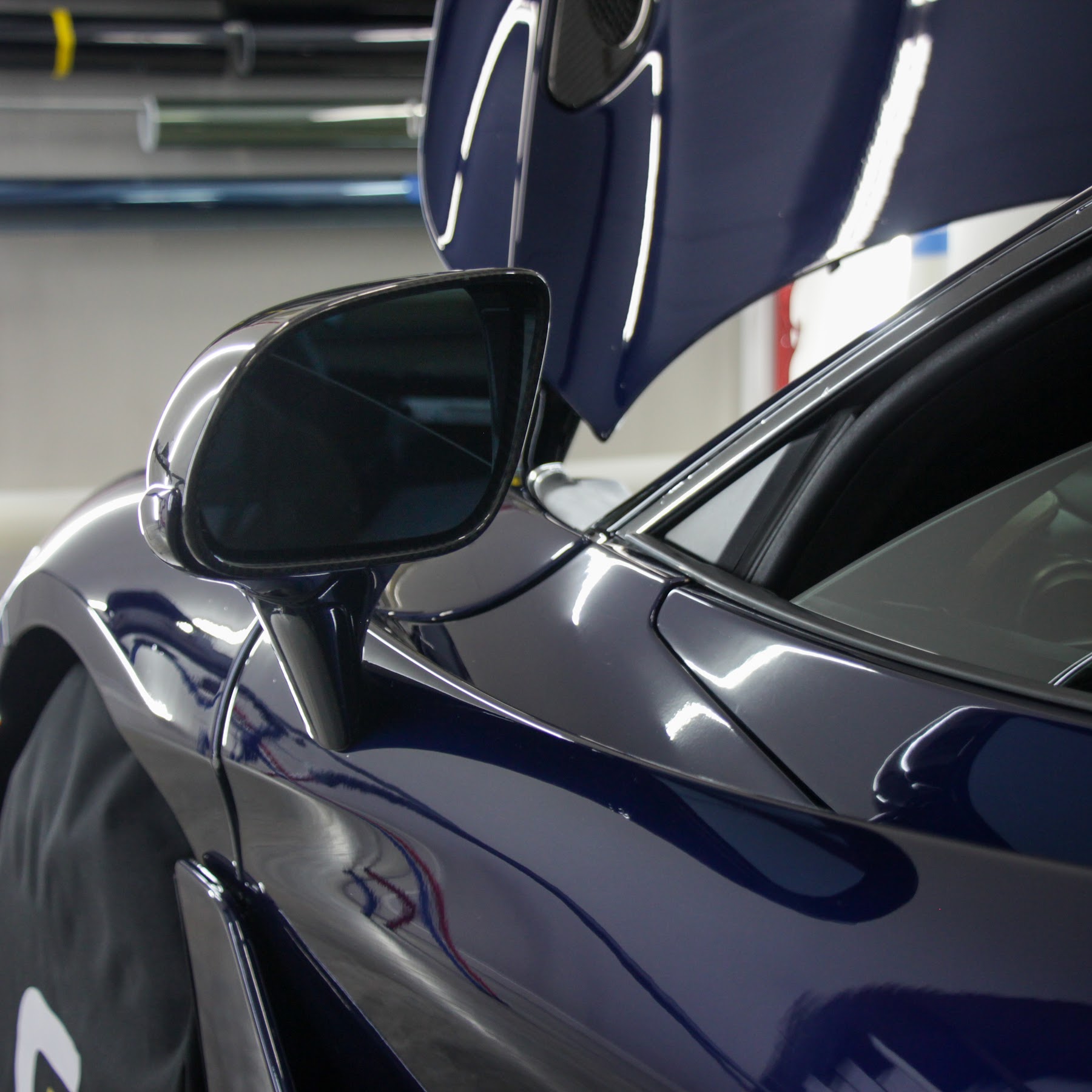 Paint protection film being installed on a Blue 2018-2021 McLaren 720S in College Station, TX Paint protection film being installed on a vehicle hood in College Station, TX
