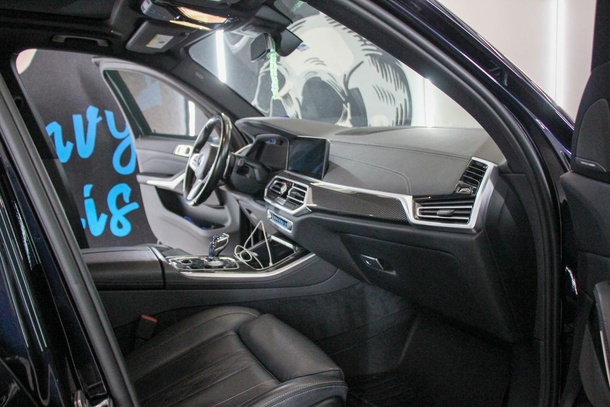 Clean BMW SUV dashboard and front seats after interior detailing in College Station